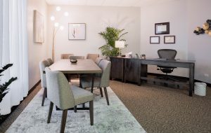 Front Range Psychological Services office in Arvada, CO with desk and meeting table with 6 chairs